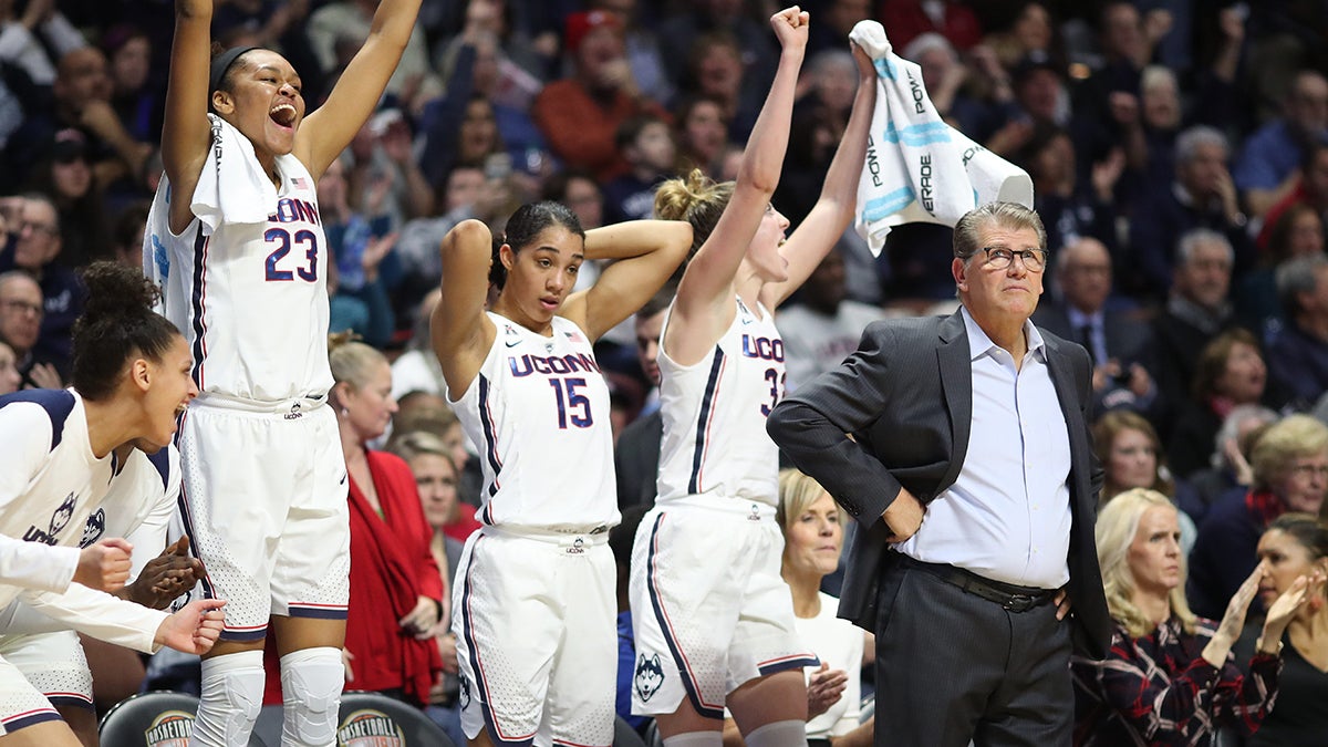 UConn women's girls basketball team cheering with Geno Auriemma