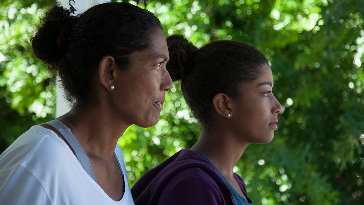 Reyana Abrahams-Ewing, a tennis prodigy in apartheid South Africa, and her daughter, Salma stare off into the distance.