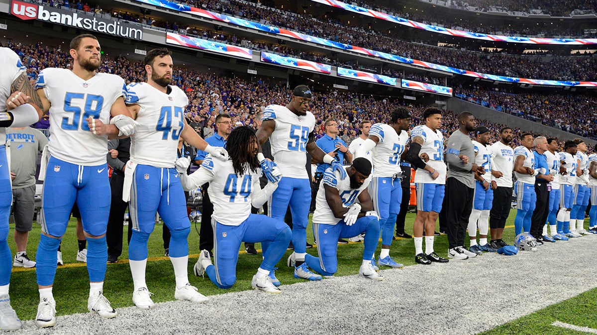 Jalen Reeves-Maybin and Steve Longa of the Detroit Lions of the NFL kneel during the national anthem to protest