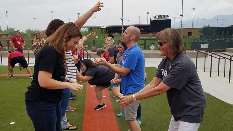 Adults playing tailgate games near Salt River Stadium