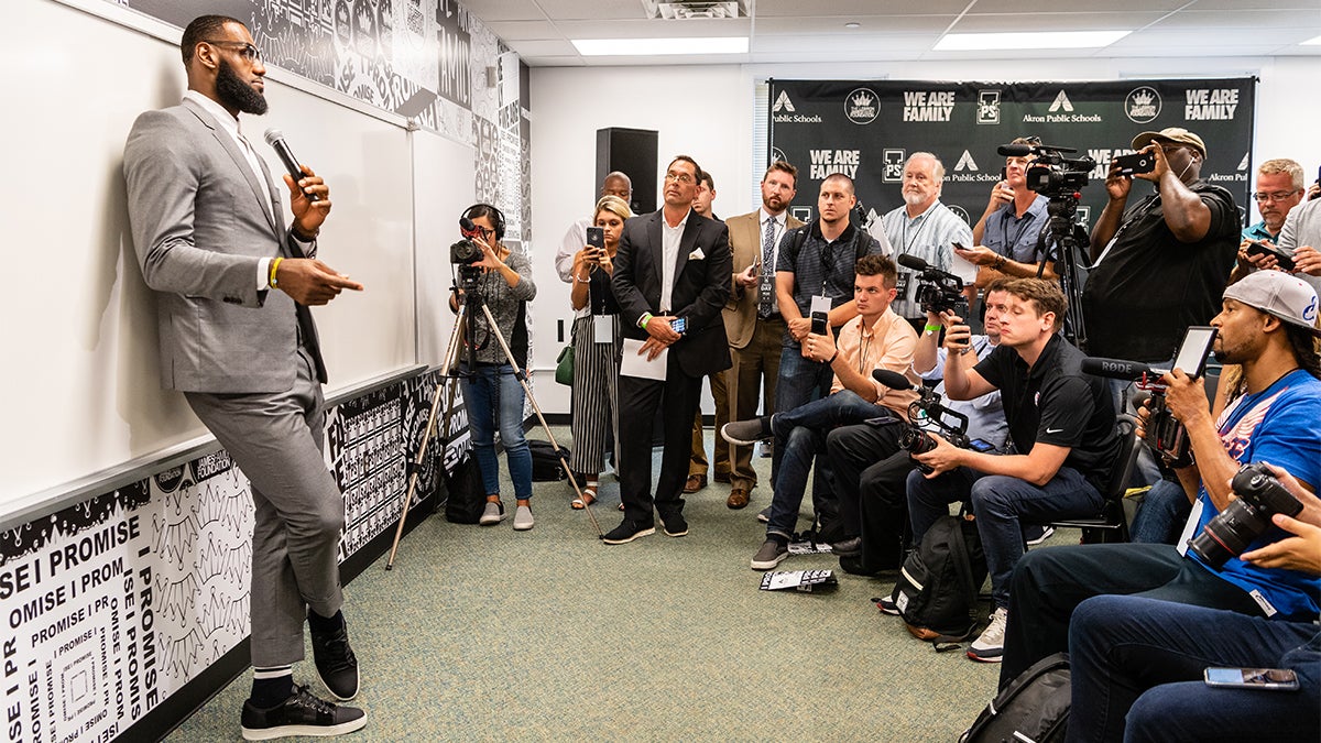 LeBron James speaking at a school to a room full of reporters