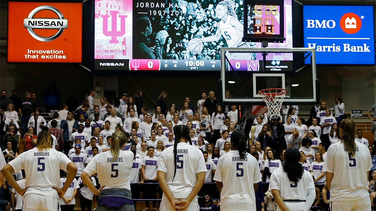 Female basketball players looking into a crowd all wearing the same jersey