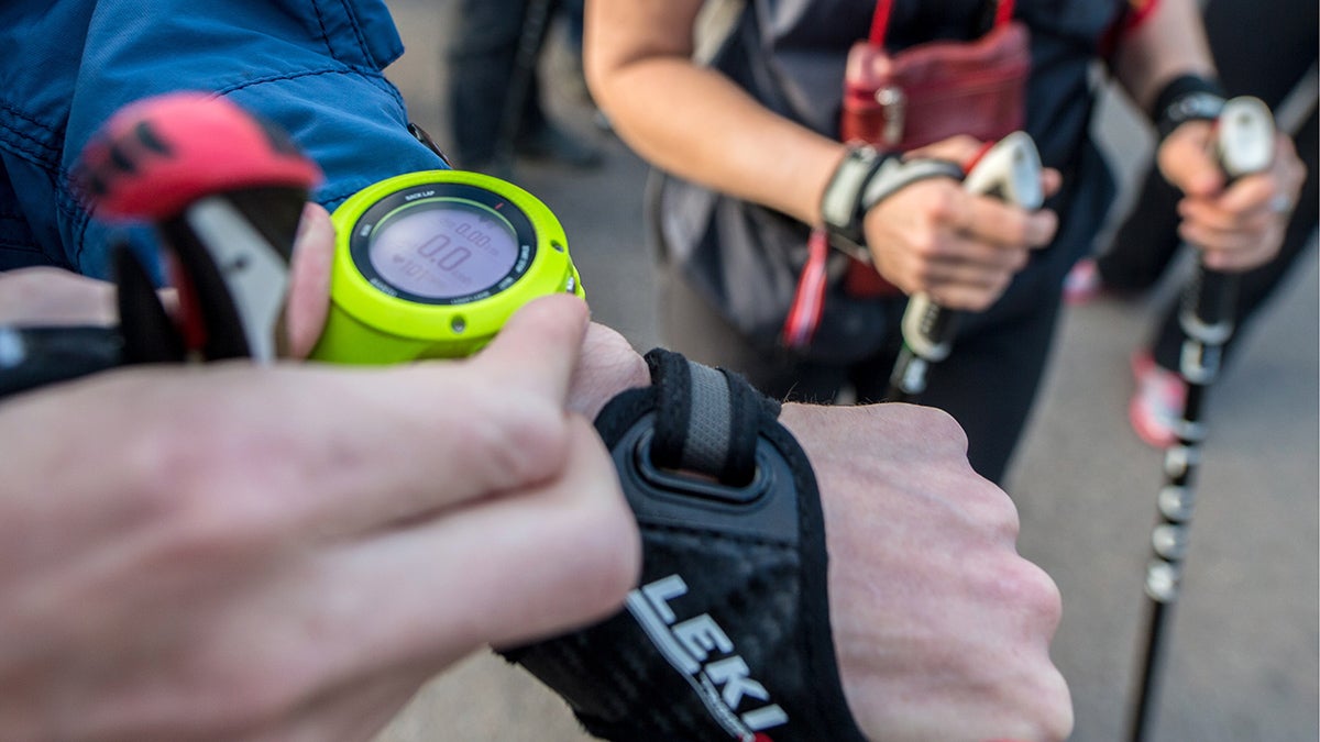 Yellow fitness watch being adjusted.